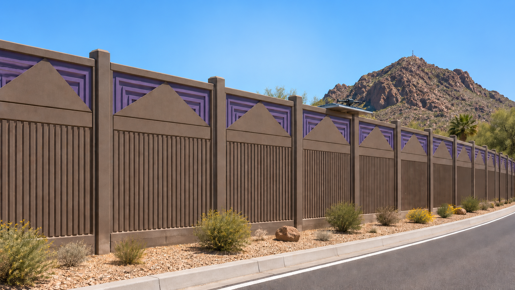 Decorative concrete noise barrier wall with purple accent panels beside a desert road in Arizona